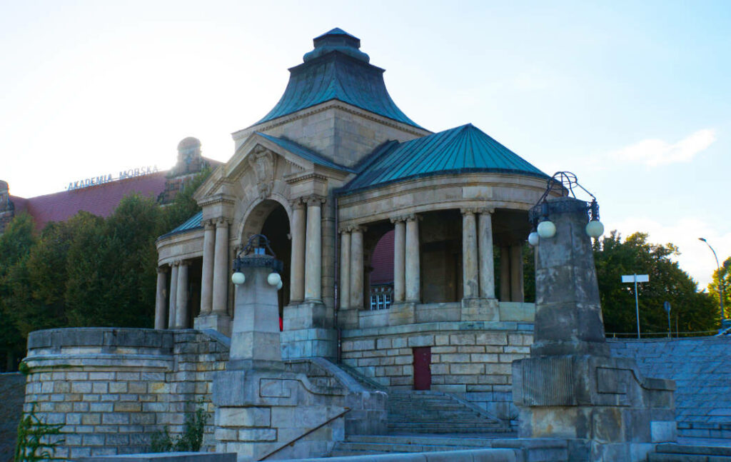 Ein historischer Pavillon mit Säulen und grünem Kupferdach an den Hakenterrassen in Stettin, gelegen am „Roten Weg“ vor dem Gebäude der Marineakademie.