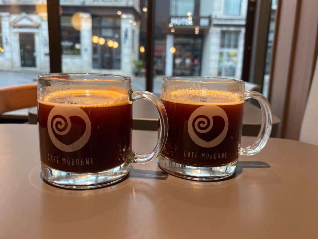 Zwei Glastassen mit frisch gebrühtem Kaffee und dem Logo des Café Morgane stehen auf einem Tisch in der Filiale in der Rue Notre-Dame in Trois-Rivières.