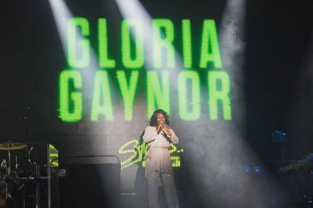 "Gloria Gaynor" singt bei der Show „Stars in Concert“ in Berlin auf einer nebelverhangenen Bühne vor einer großen grünen Leuchtschrift mit ihrem Namen.
